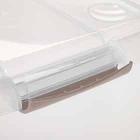 Durable Iris USA plastic bin in gray-clear finish blends with bedroom decor.