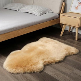 IRIWOOL sheepskin rug in a cozy bedroom setup for elegant warmth