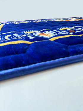 Islamika royal blue prayer rug in use during quiet supplication