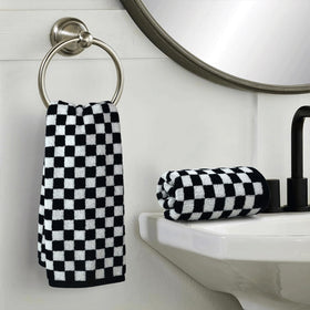 Jacquotha bathroom decor with towels on rack enhancing chic, coordinated space.