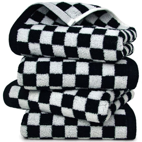 Jacquotha black and white towels folded, versatile four-pack for stylish bathroom use.