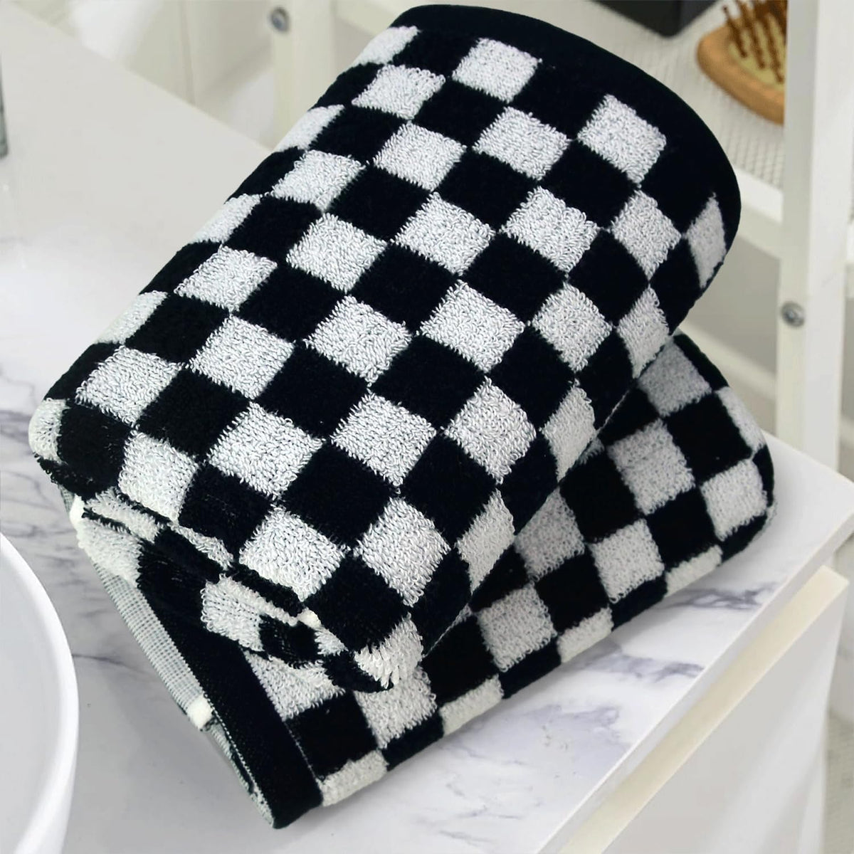 Jacquotha kitchen-use towels in checkered pattern ideal for quick hand drying by sink.