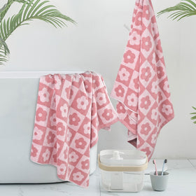 Jacquotha pink towels stacked, showcasing large size for full-body wrap after baths.