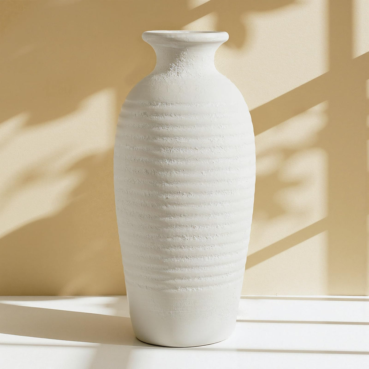 Jaxoriel rustic ceramic vase with threaded white surface, ideal for dramatic centerpieces.