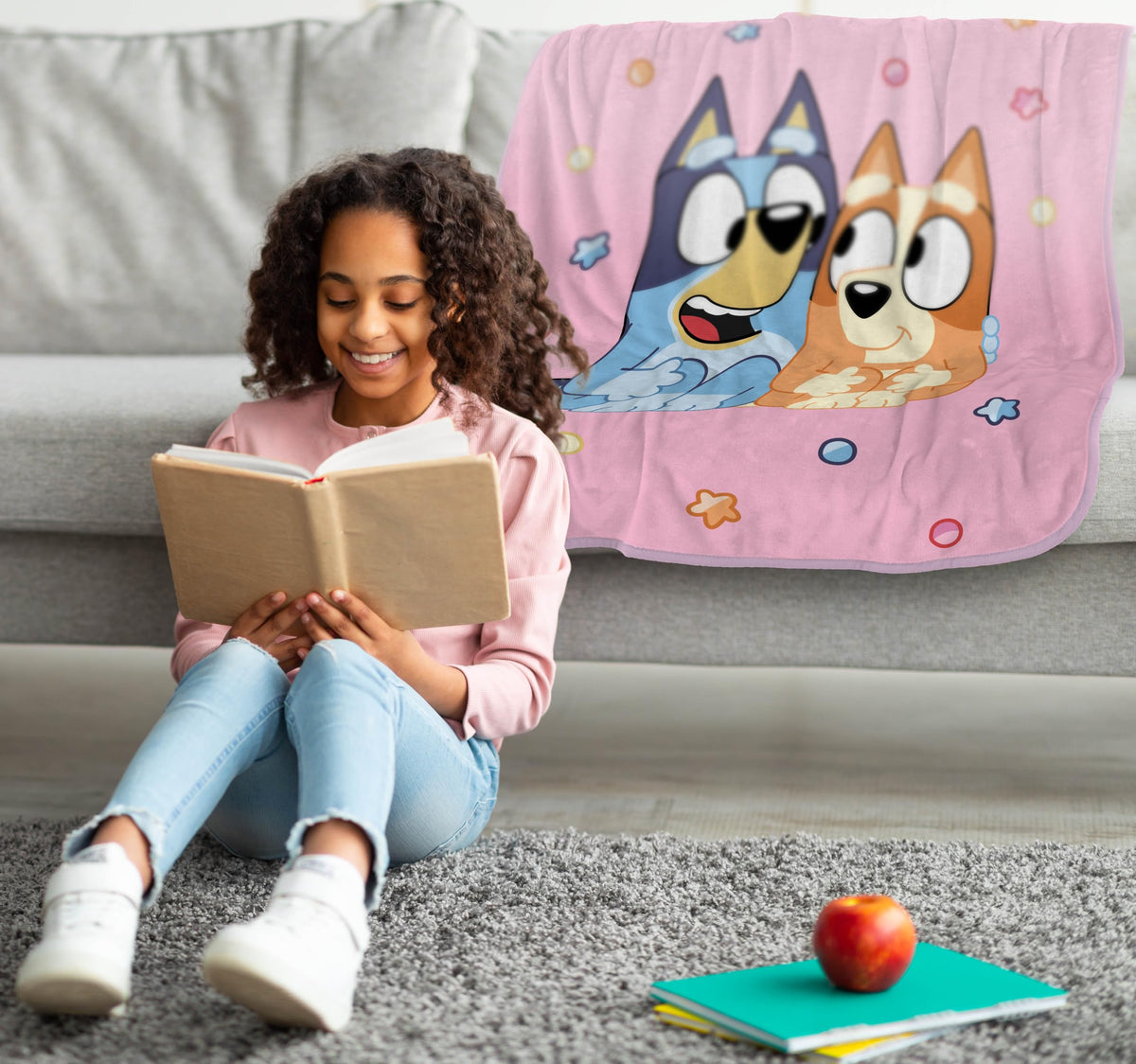Bluey plush throw displayed on bed setup for warmth and style