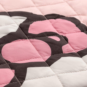 Bedroom display demonstrates vibrant pink stripes and hearts for playful decor