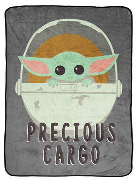 Jay Franco Mandalorian Baby Yoda in a spaceship on a soft throw for cuddling.