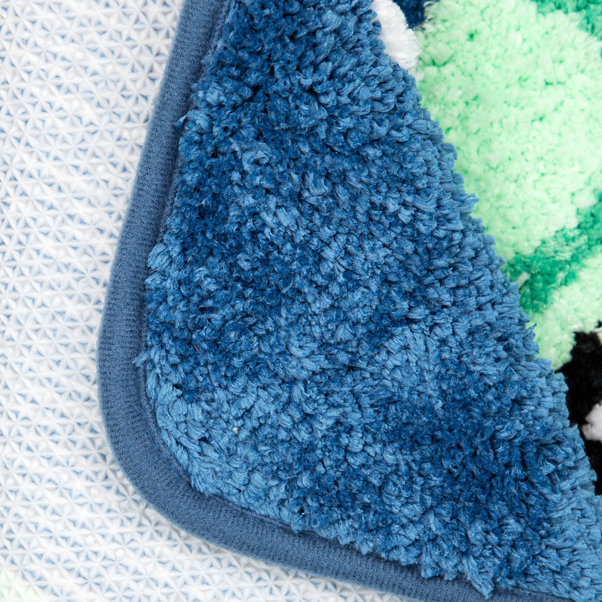 Jay Franco Star Wars Mandalorian blue rug in kids' bathroom with non-slip backing.