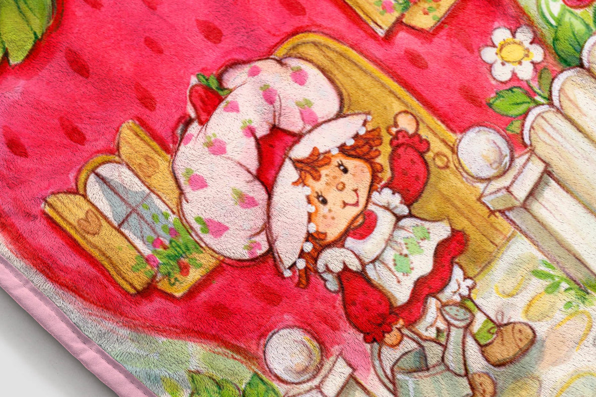 Jay Franco Strawberry Shortcake plush blanket folded display, lightweight warmth for travel.