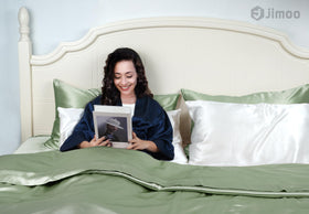 Close-up texture of J JIMOO silk reveals soft, breathable fabric.
