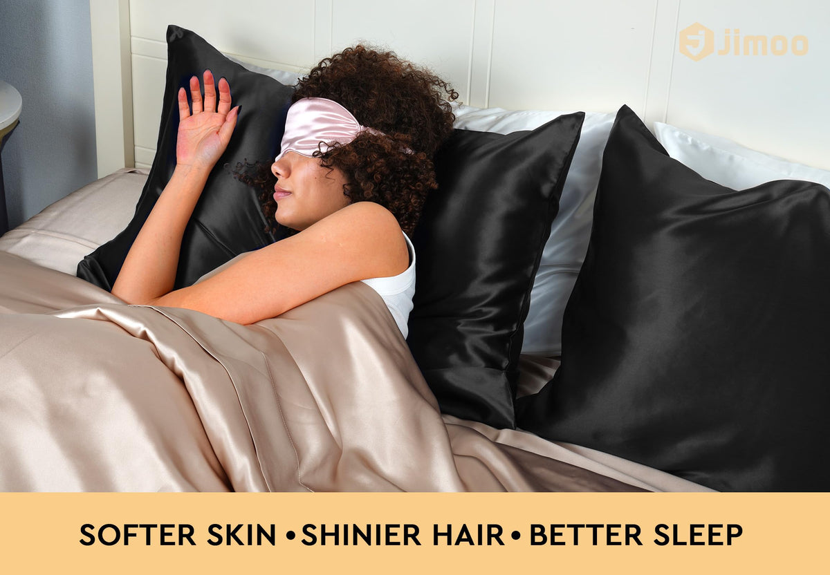 J JIMOO silk pillowcase on black bed for a sleek, luxurious look.