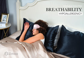 J JIMOO silk pillowcase on bed in navy enhances sleeping environment.