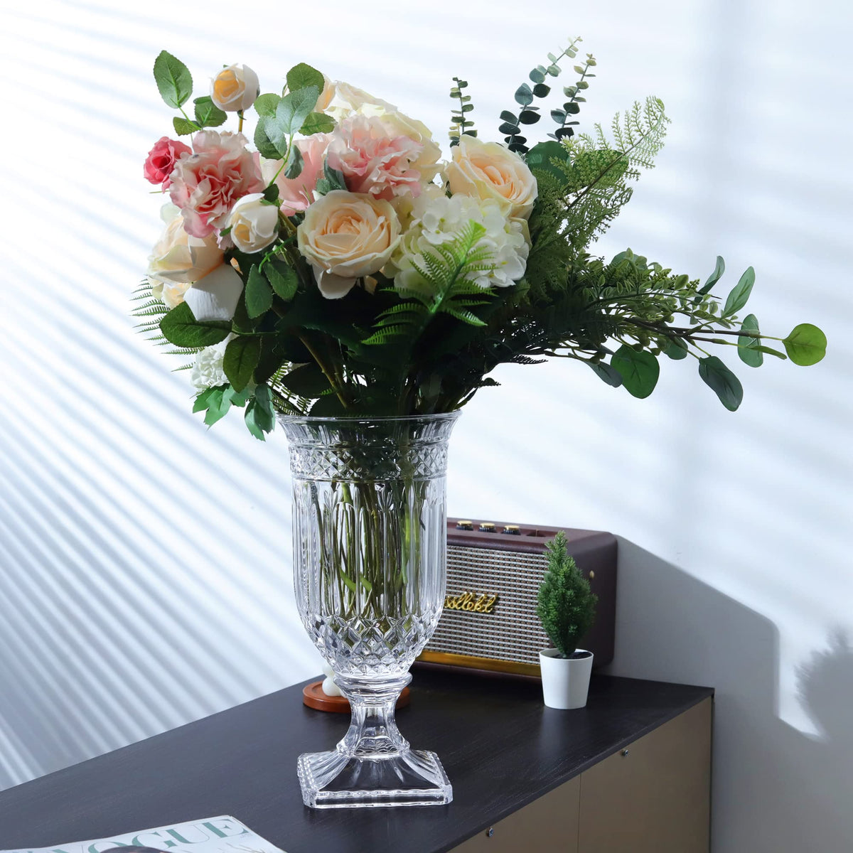 Joeyan clear glass vase features thick base for added stability.