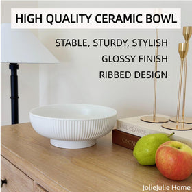 JolieJulie cream white bowl used as a purse and key organizer on a counter.