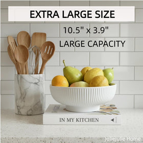 JolieJulie ceramic fruit bowl on dining table as a modern centerpiece with fruit.
