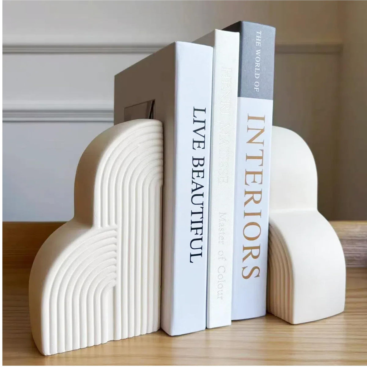 JolieJulie concrete bookends stabilizing heavy books on a sturdy shelf