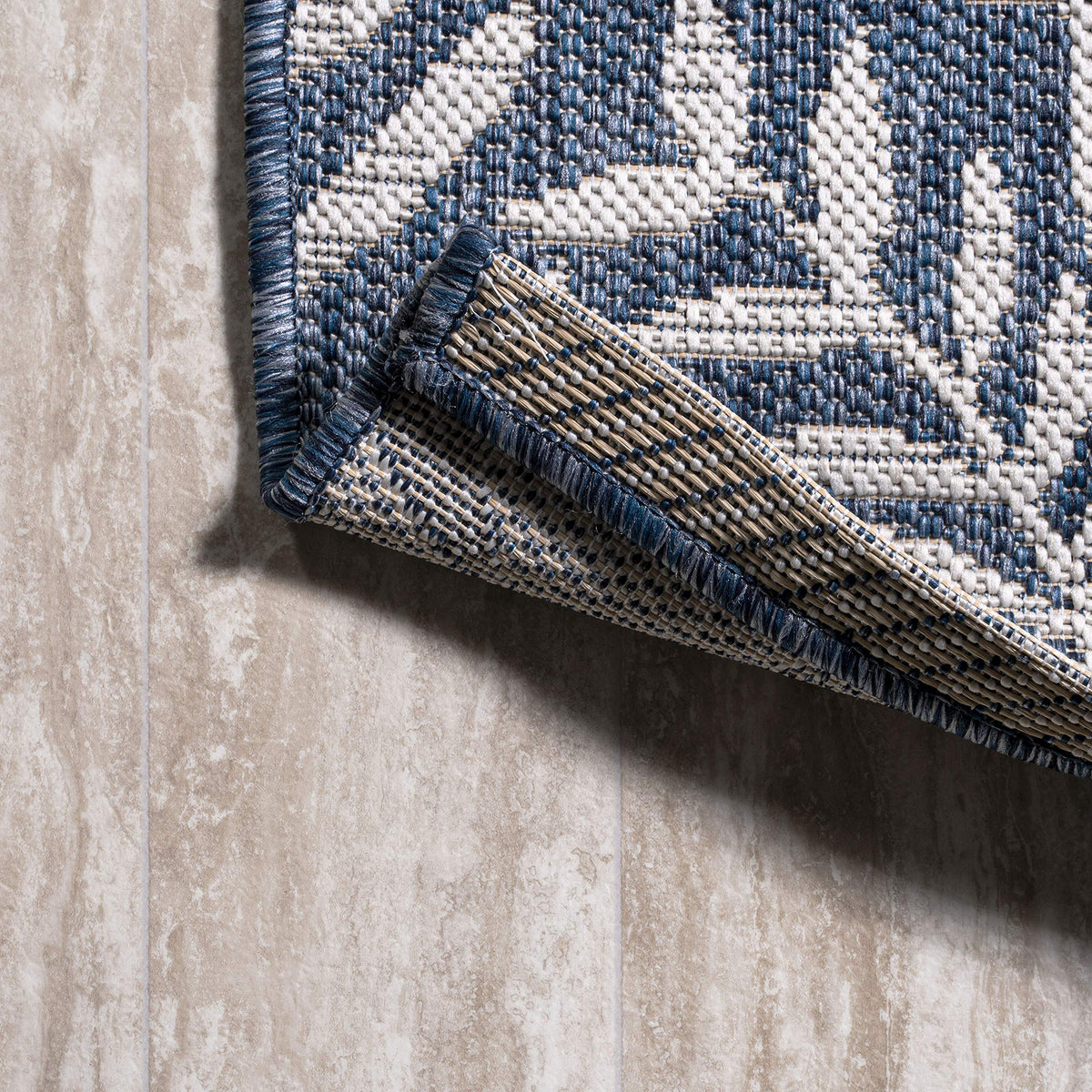 Jonathan Y navy and cream palm pattern complements porches and patios.