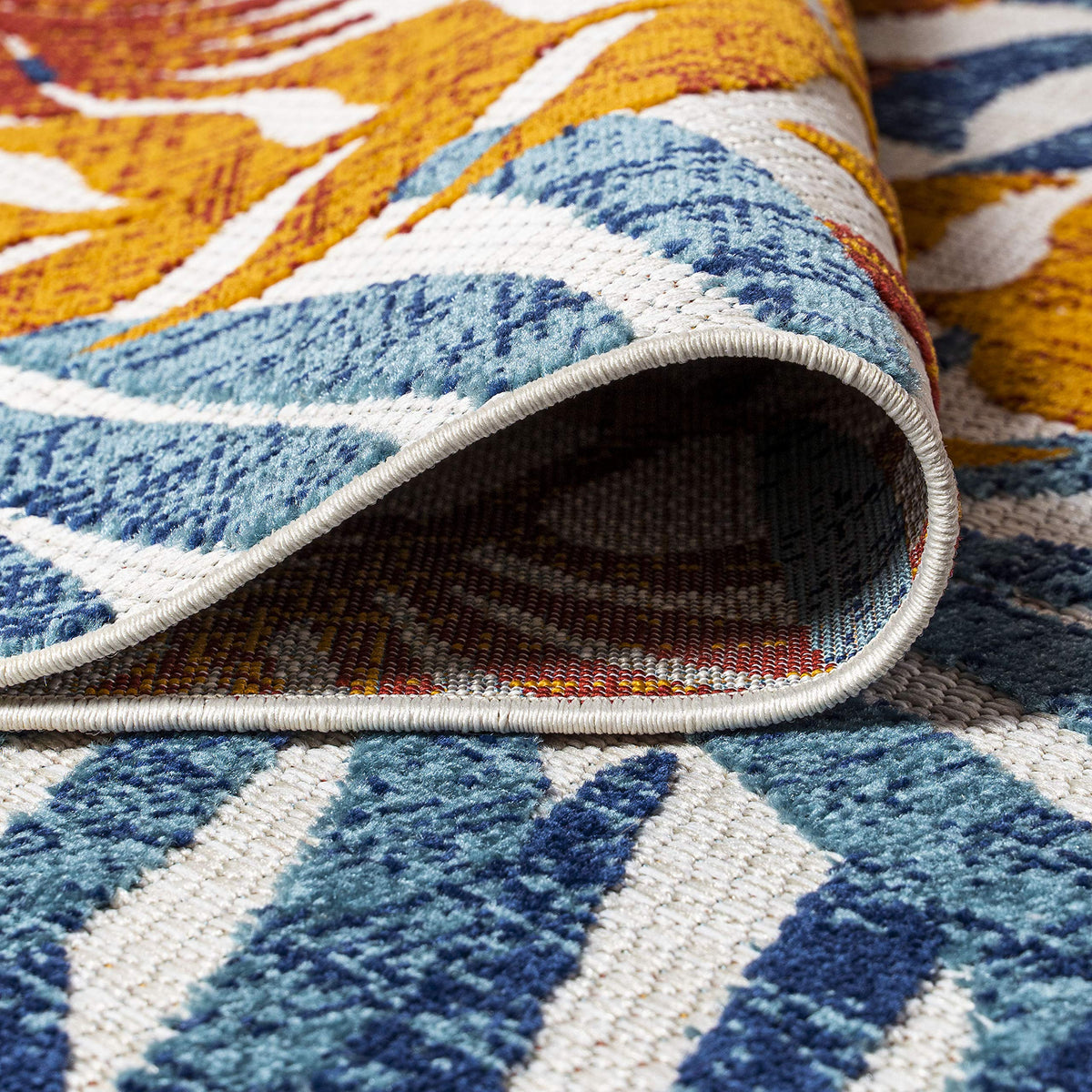 Boho-inspired Tropics rug complements living spaces with vibrant palm colors.