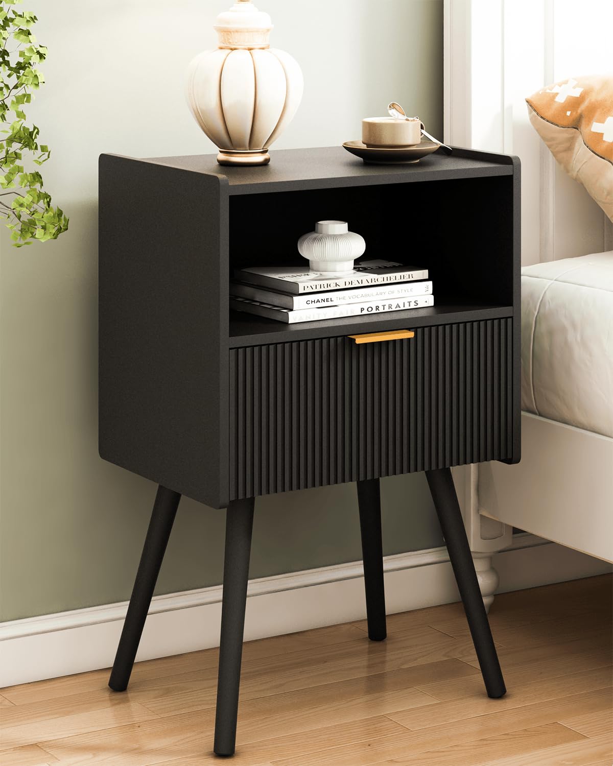JOONEE black nightstand beside bed with storage drawer for organized essentials.