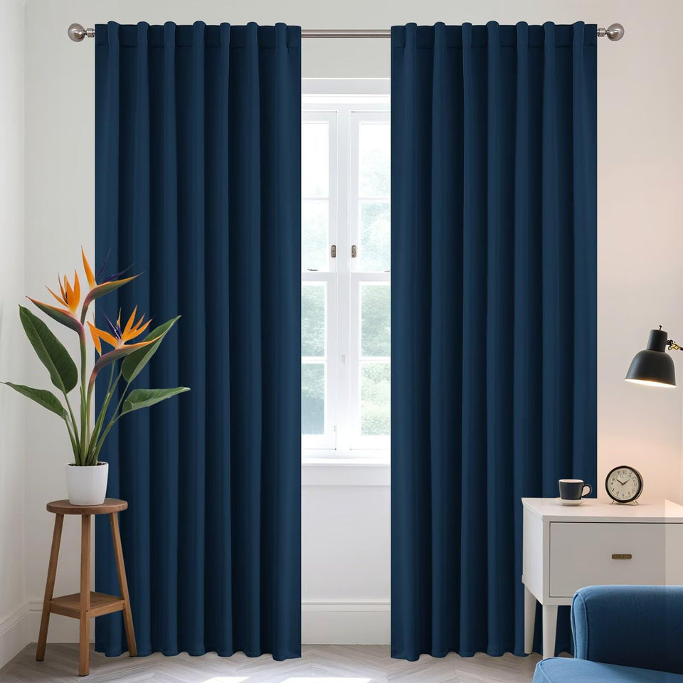 Joydeco blackout curtains in navy blue, 2-panel setup, blocks light for better sleep.