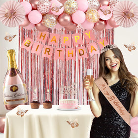 Juesly hanging pink paper fans add soft color and depth to the party backdrop.