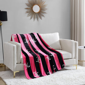 Juicy Couture Cabana Plush throw on sofa adds luxurious warmth and style.
