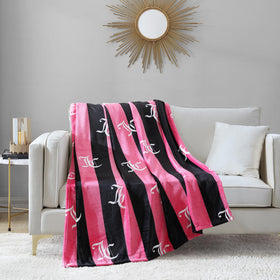 Oversized 50x70 throw draped over a chair for cozy lounging.