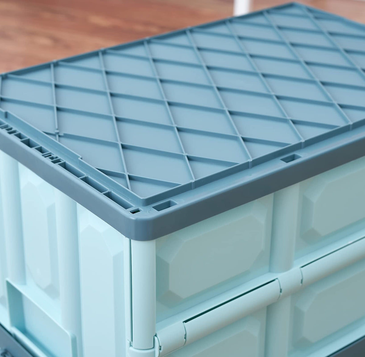 JUJIAJIA blue folding crate folded flat for compact storage.