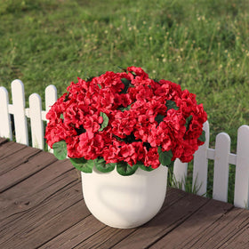 Close-up of red blooms on Juxdp topiary with lifelike texture.
