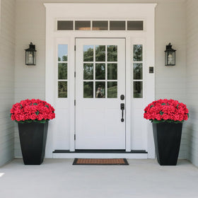Two weighted pots stabilize the Juxdp topiaries on steps.