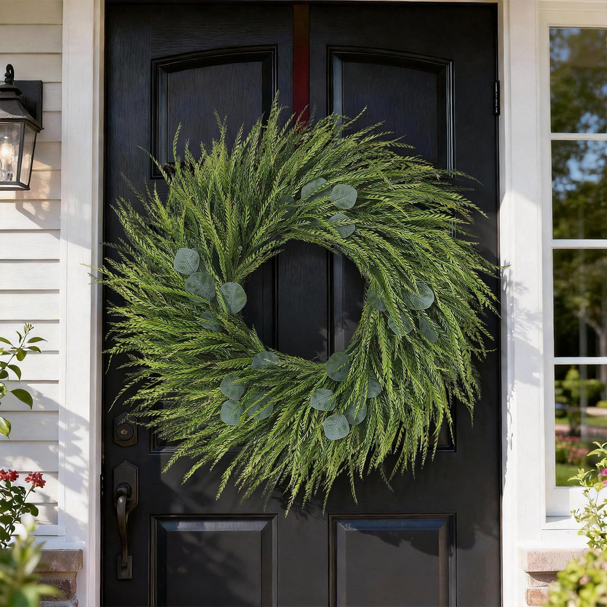 Juxdp wreath above fireplace creates a welcoming farmhouse centerpiece.