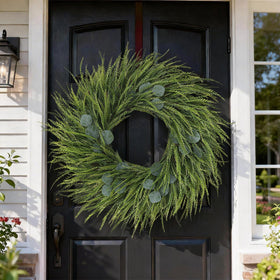 Juxdp wreath above fireplace creates a welcoming farmhouse centerpiece.