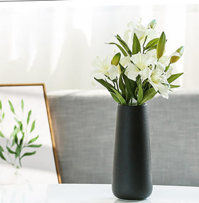 JUZAI sculptural vase serves as a striking focal point on any table.