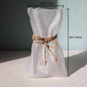 Kaitnax vase enhances living room decor with clear glass elegance.