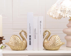 Kakizzy Swan resin bookends create a sturdy display for magazines and paperbacks.