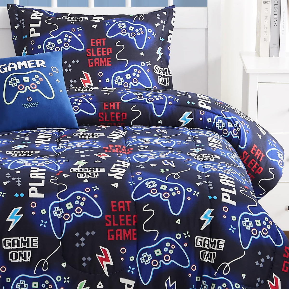 Kaleido Space glow decor pillow adds luminous flair to kid's bed setup.
