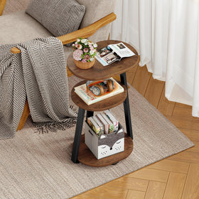Kalrin oval side table beside sofa for drinks and remotes.