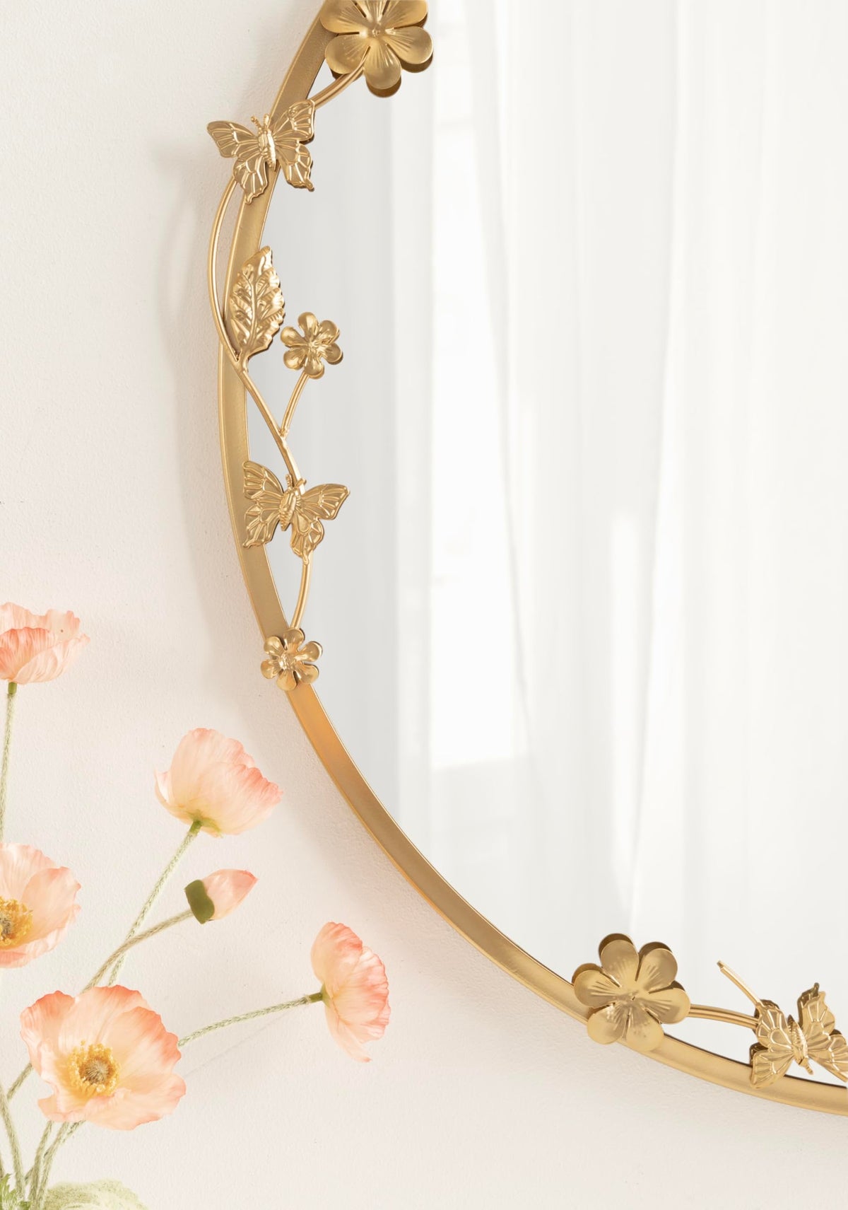 Rosella bathroom vanity mirror reflects light with gold luxe finish.