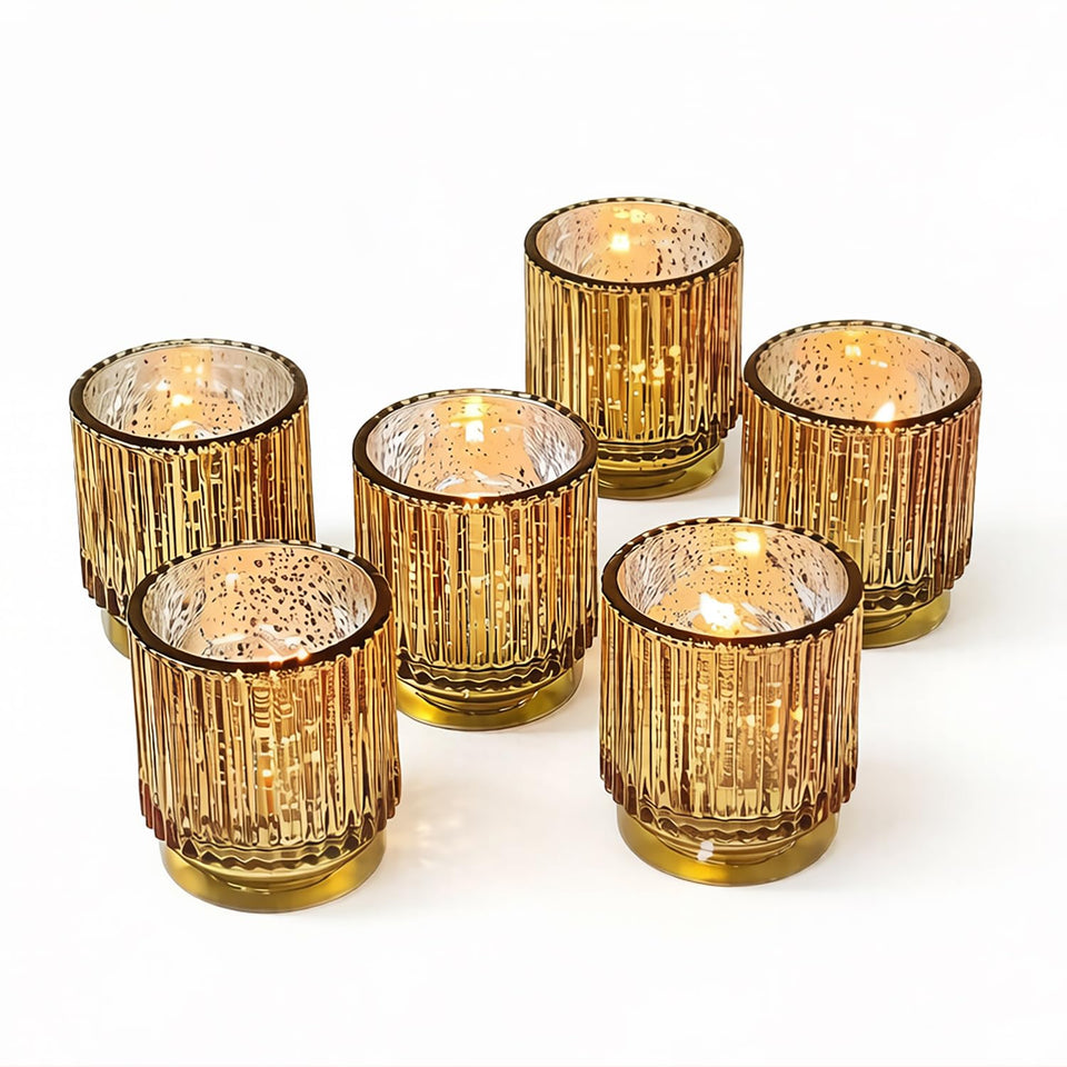 Kate Aspen gold ribbed votive holders arranged on a tray for warm holiday glow.