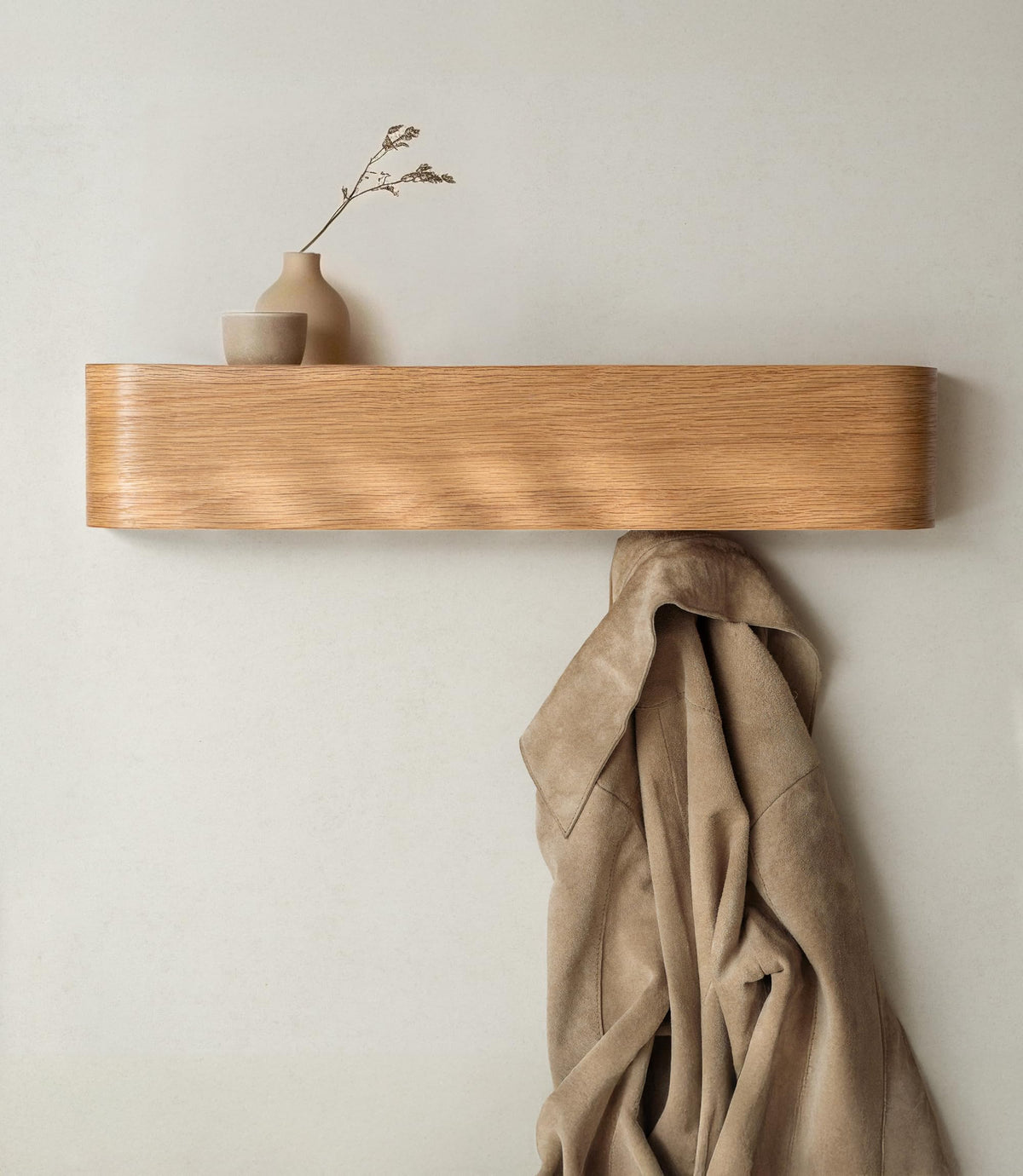 Kazai Toke wall-mounted coat rack with hidden hooks in a slim entryway.