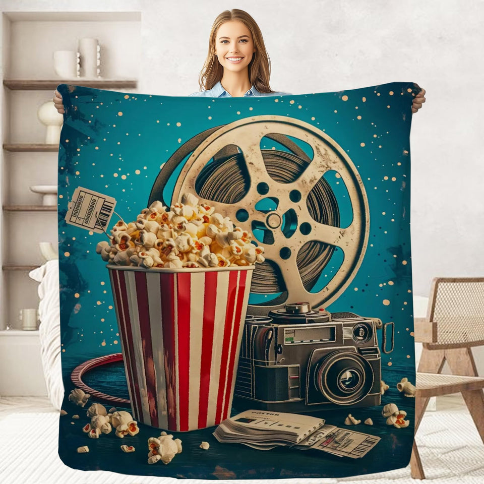 keepitcozi Movie Popcorn Blanket folded on a sofa for cozy movie nights