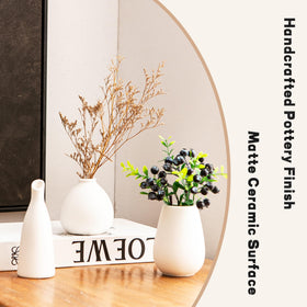 Kendiis durable ceramic vases with smooth bases safe on wood surfaces.