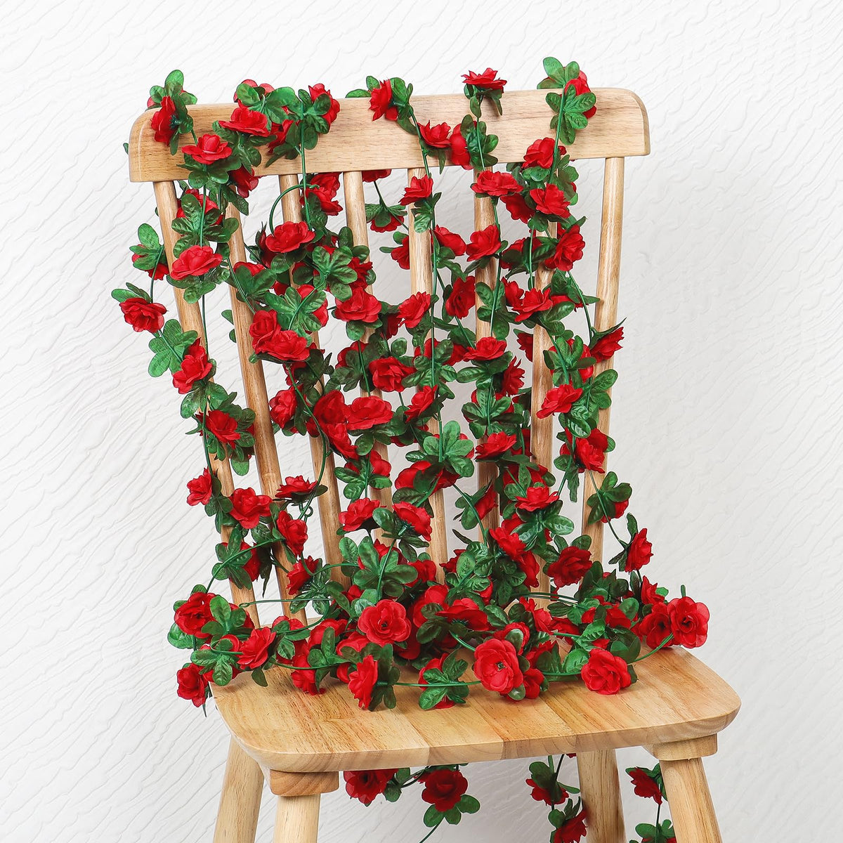 KHOYIME red rose garland along an outdoor entry for welcoming flair