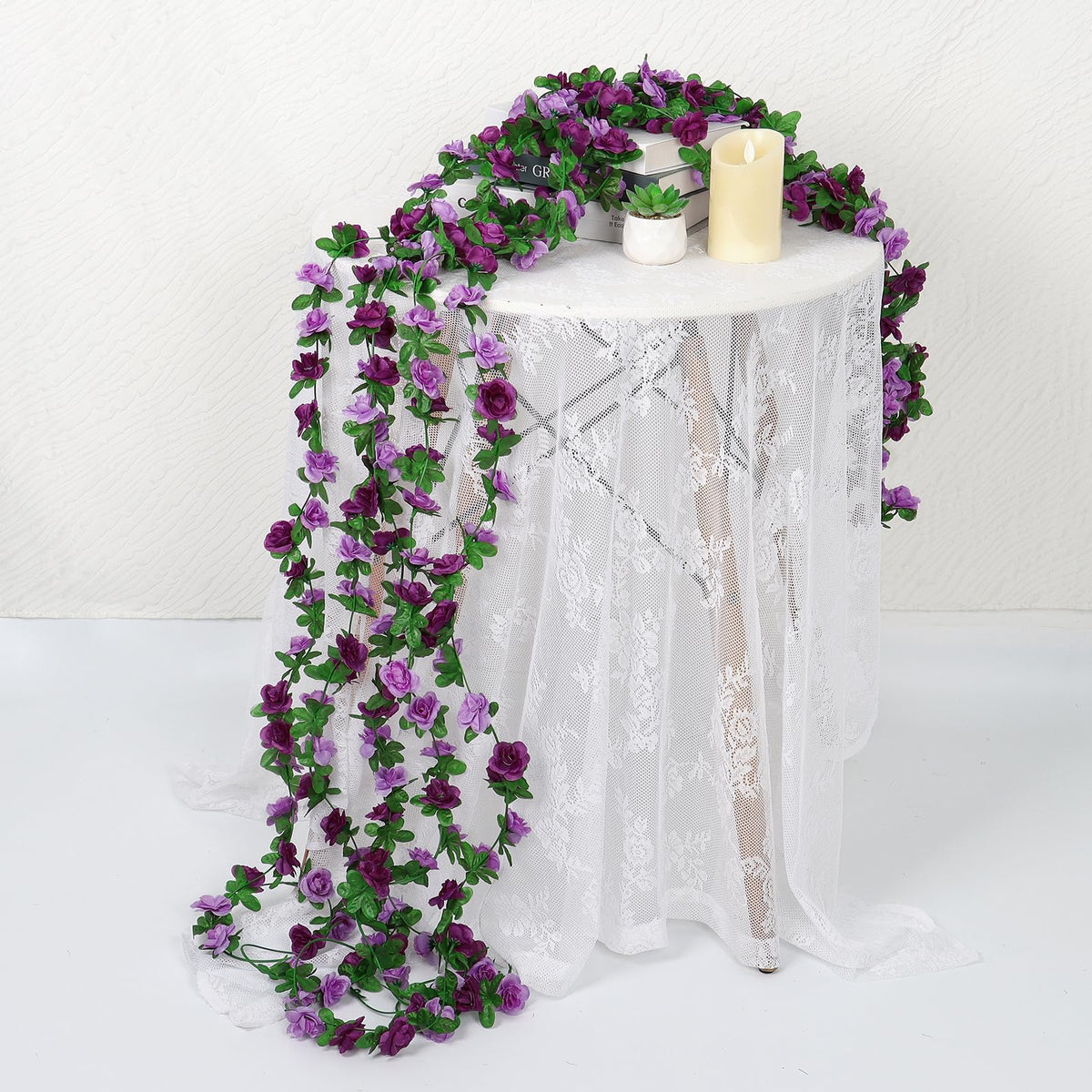 Khoyime pink floral garland enhances dining table decor with soft color.