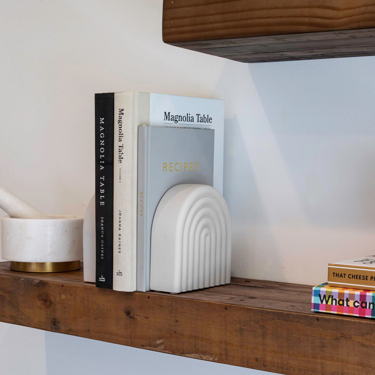 KIBAGA rainbow-arch bookends stand out as a stylish shelf centerpiece.