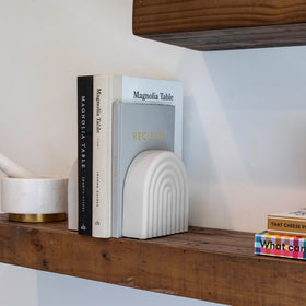 KIBAGA rainbow-arch bookends stand out as a stylish shelf centerpiece.
