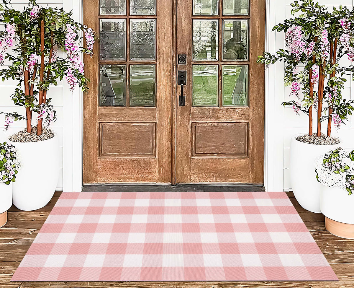 KIhipIoe pink plaid rug for bedside area, adds warmth.