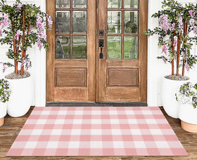 KIhipIoe pink plaid rug for bedside area, adds warmth.
