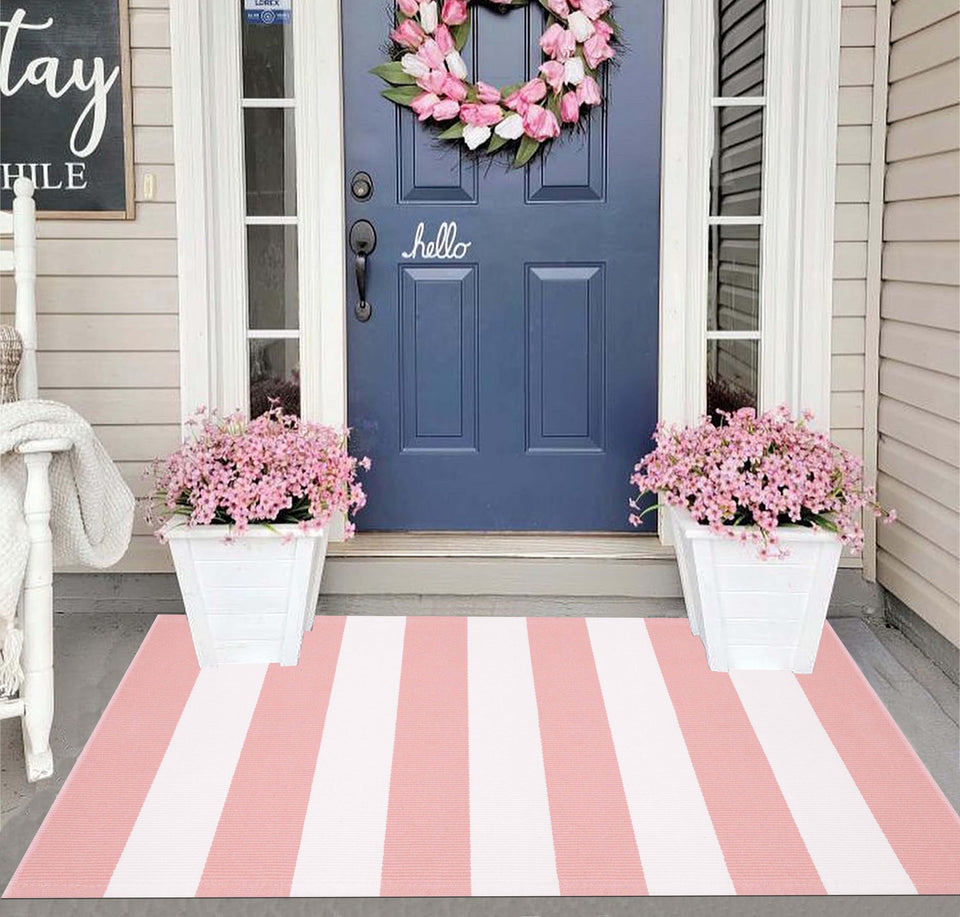 KIhipIoe striped area rug in pink and white adds a welcoming porch ambiance.
