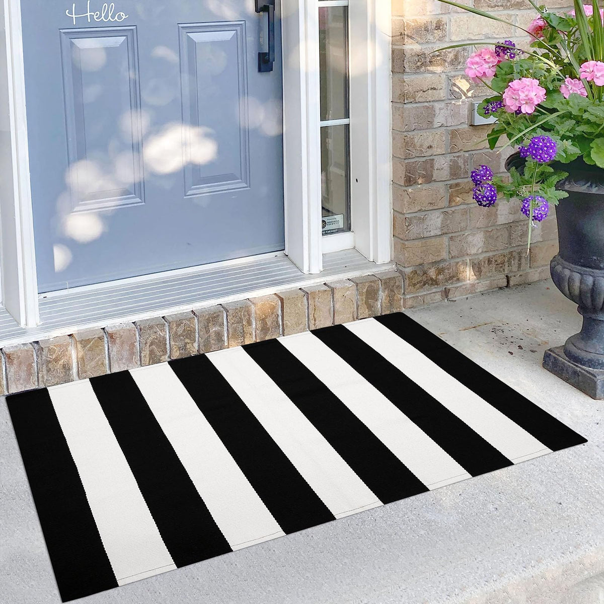 KILOCOCO black and white striped rug on a front porch, durable indoor/outdoor use.